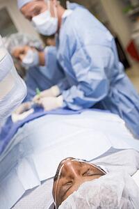 Surgeons Operating On Patient