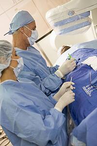 Surgeons Operating On Patient