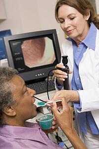 Doctor Administering Medicine To Patient