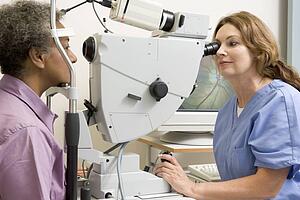 Nurse Checking Patient's Eyes