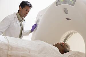 Doctor With Patient Having A Computerized Axial Tomography (CAT) Scan