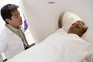 Doctor With Patient Having A Computerized Axial Tomography (CAT) Scan