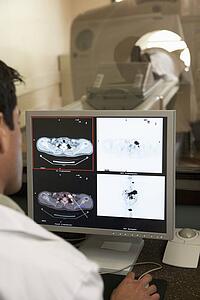 Doctor Monitoring Patient Having Computerized Axial Tomography (CAT) Scan