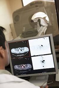 Doctor Monitoring Patient Having Computerized Axial Tomography (CAT) Scan