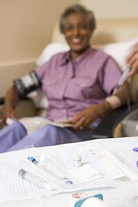 Medical Equipment On A Table With A Patient In The Background