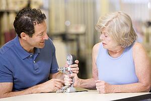 Physiotherapist With Patient In Rehabilitation