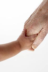 Grandfather and granddaughter holding hands