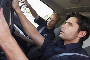 Ambulance driver and colleague on the way to an emergency