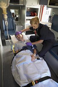 Paramedic with patient in ambulance