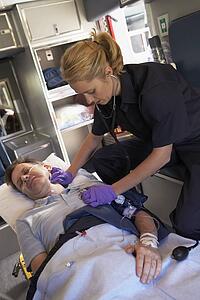 Paramedic with patient in ambulance