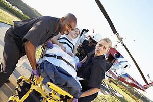 Paramedics unloading patient from Medevac