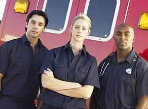 Portrait of paramedics standing in front of an ambulance