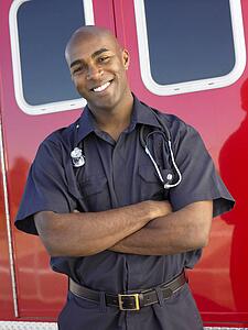 Portrait of paramedic in front of ambulance