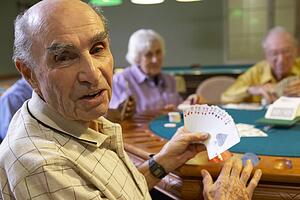 Senior adults playing bridge