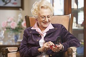 Senior woman text messaging