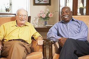 Senior men relaxing in armchairs