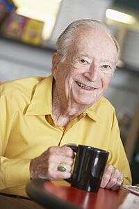 Senior man drinking hot beverage