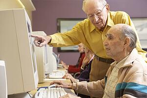 Senior men using computer