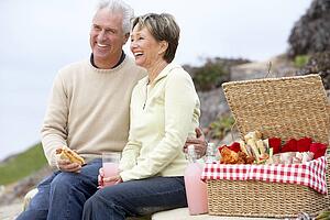 Couple Eating An Al Fresco Meal At The Beach
