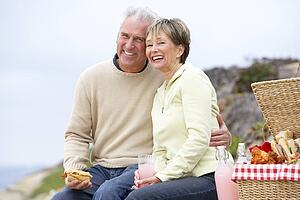 Couple Eating An Al Fresco Meal At The Beach