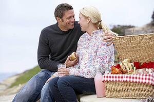 Couple Eating An Al Fresco Meal At The Beach