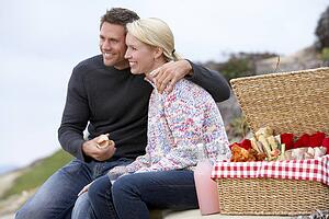 Couple Eating An Al Fresco Meal At The Beach