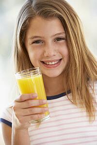 Young Girl Drinking Orange Juice