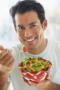 Mid Adult Man Eating Salad