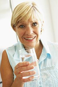 Middle Aged Woman Drinking A Glass Of Water