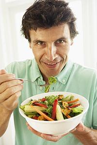 Mid Adult Man Eating A Healthy Salad