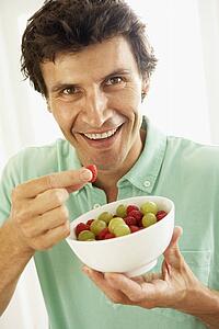 Mid Adult Man Eating Fresh Fruit