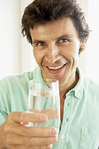Mid Adult Man Drinking A Glass Of Water