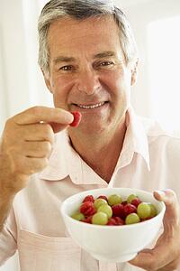 Middle Aged Man Eating Fresh Fruit