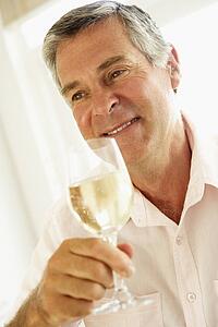 Middle Aged Man Drinking A Glass Of Wine
