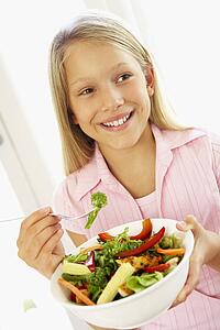 Young Girl Eating Fresh Salad