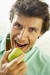 Mid Adult Man Eating A Healthy Apple