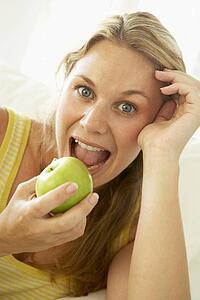 Mid Adult Woman Eating A Healthy Apple