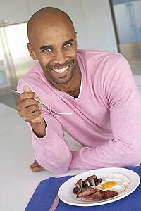 Middle Aged Man Eating Unhealthy Fried Breakfast