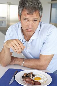 Middle Aged Man Eating Unhealthy Fried Breakfast