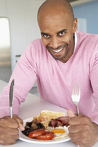Middle Aged Man Eating Unhealthy Fried Breakfast