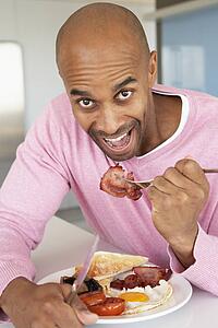 Middle Aged Man Eating Unhealthy Fried Breakfast
