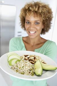 Mid Adult Woman Holding A Plate With Healthy Food