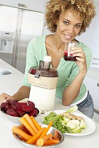 Mid Adult Woman Making Fresh Vegetable Juice