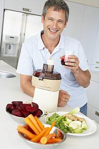 Middle Aged Man Making Fresh Vegetable Juice