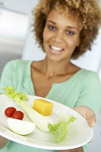 Mid Adult Woman Holding A Plate Of Healthy Food