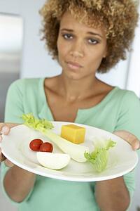Mid Adult Woman Holding A Plate Of Healthy Food