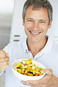 Middle Aged Man Eating Fresh Fruit Salad