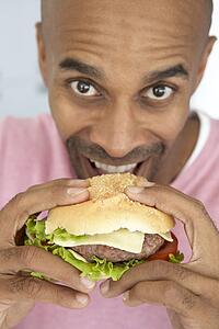 Middle Aged Man Eating A Burger