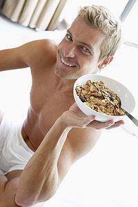 Mid Adult Man Eating A Bowl Of Cereal