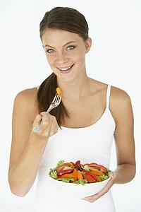 Young Woman Eating Fresh Salad